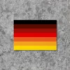 Produktbild für einen Stolzmonat / Stolzflagge Deutschland Sticker in Größe Din A8, der im Rahmen des Stolzmonats entstanden ist. Er hat sieben Farbabstufungen von Schwarz zu Rot zu Gold. Das Ganze ist angelehnt an die progressive LGBTQ Stolzflagge.